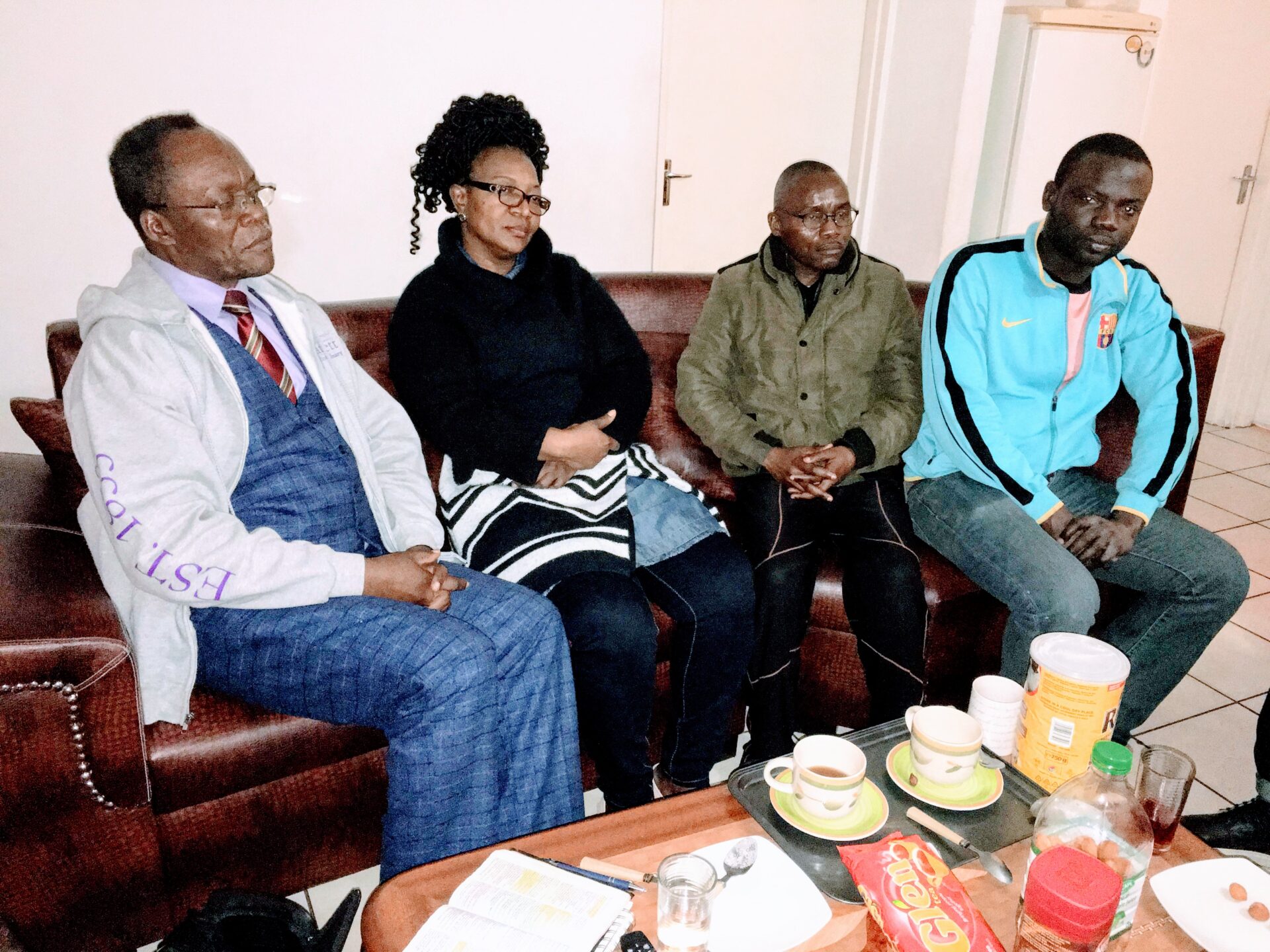 Four Individuals Drinking Tea