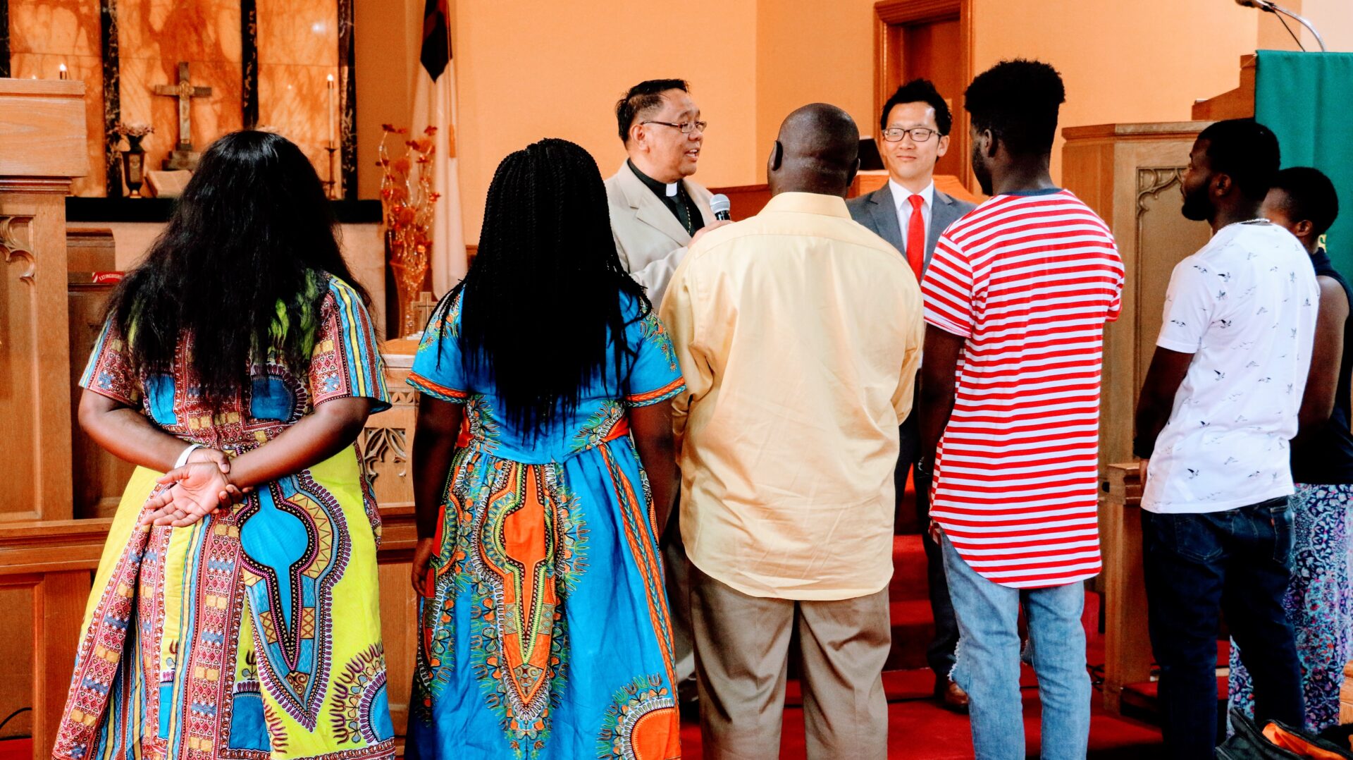 Six Individuals Listening to the Priest