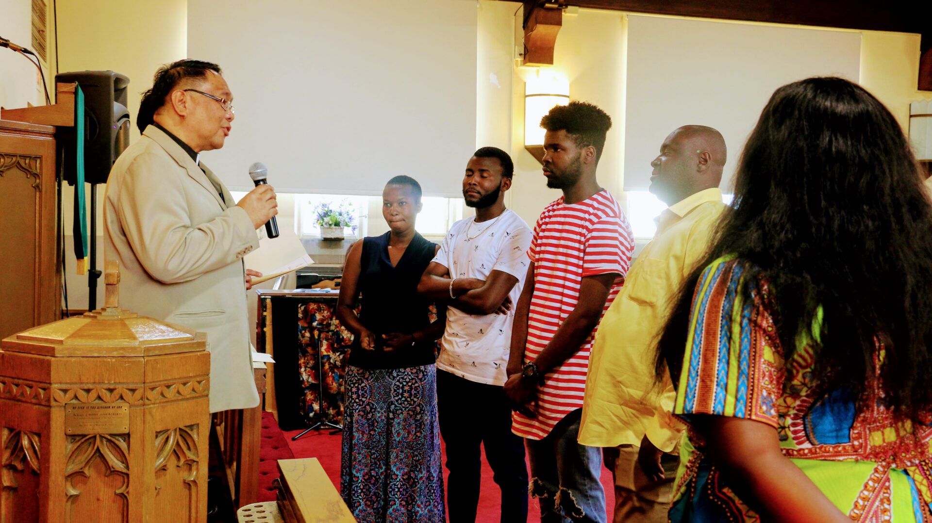 Six Individuals in Front Listening to the Priest