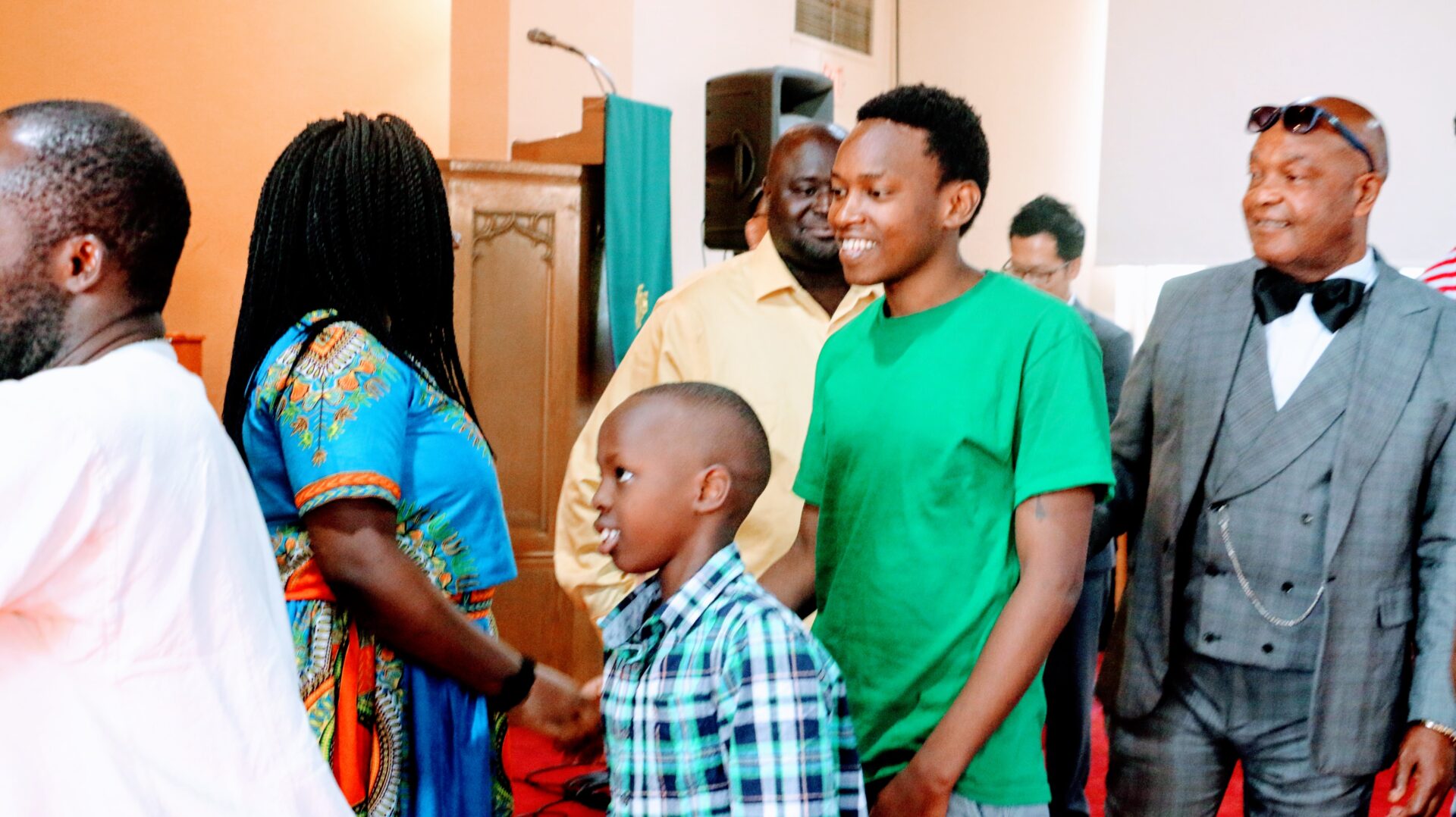 Individuals Greeting a Woman Inside the Church