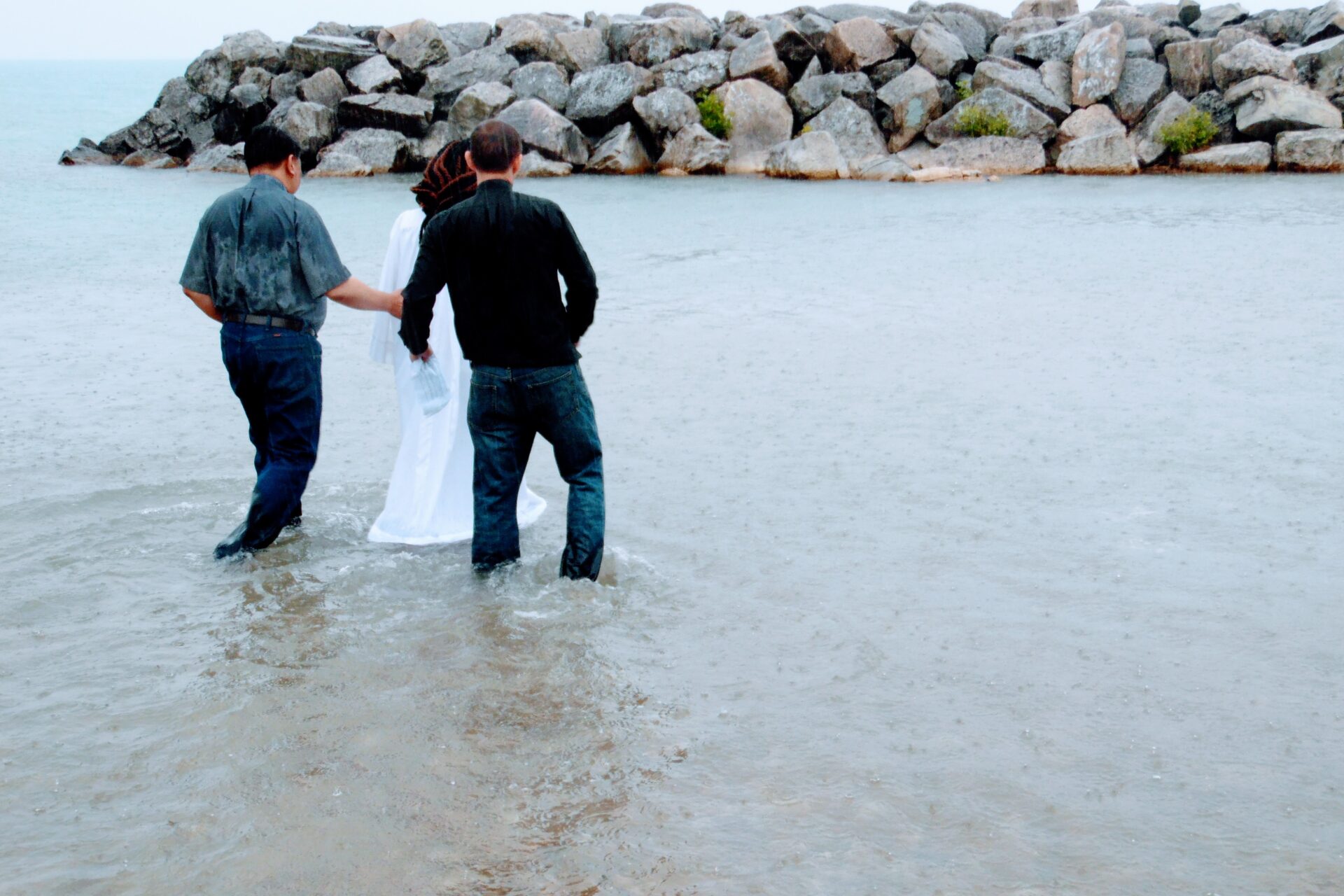 Two Men and a Woman Going Toward the Beach