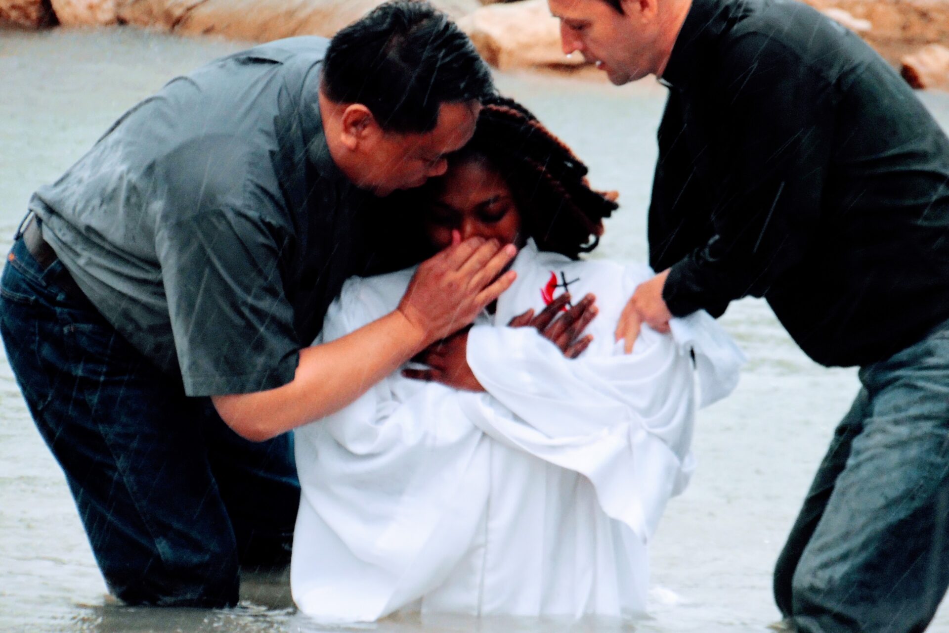 Two Men Saying a Prayer to a Woman