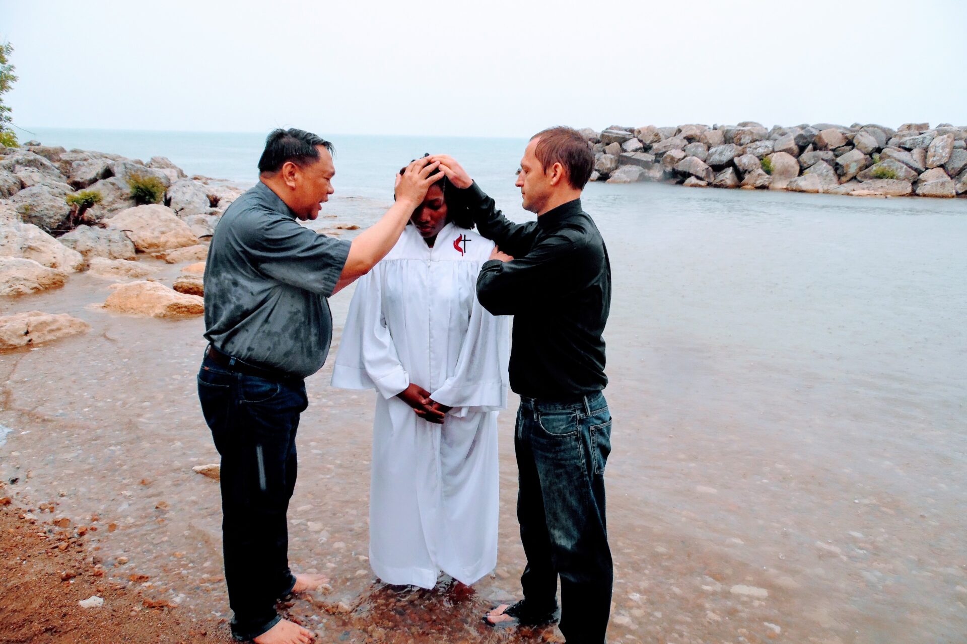 Two Men Saying a Prayer to a Woman