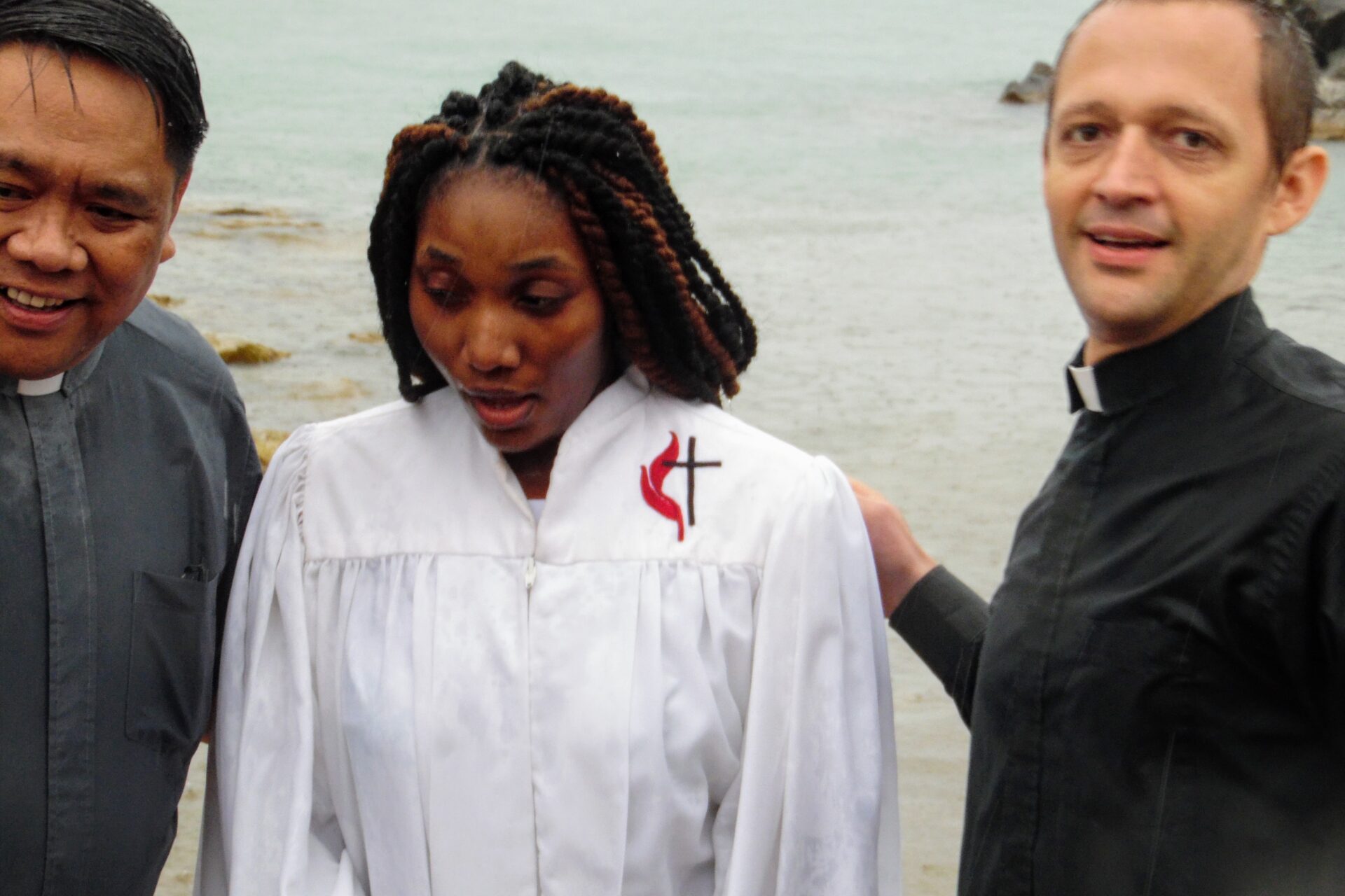 Two Men and a Woman Walking in the Beach