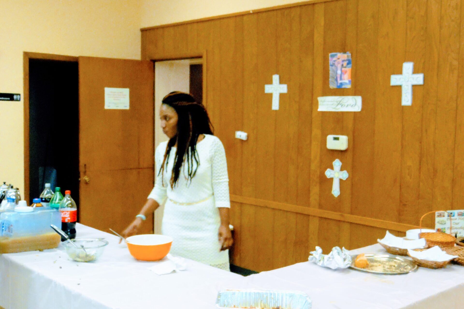 A Woman in White Getting Food