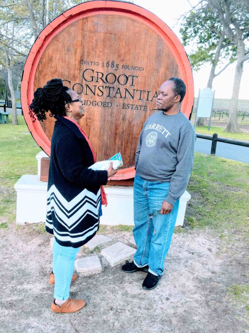 Two Individuals Posing in Front of Groot Constantia